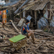 A resident sits outside destroyed houses after Typhoon Vamco hit on Nov. 14, 2020 in Rodriguez, Philippines.